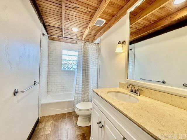 full bathroom with shower / tub combo, wood-type flooring, wooden ceiling, beamed ceiling, and toilet