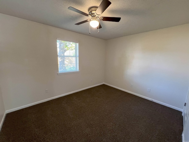 carpeted spare room featuring a textured ceiling and ceiling fan