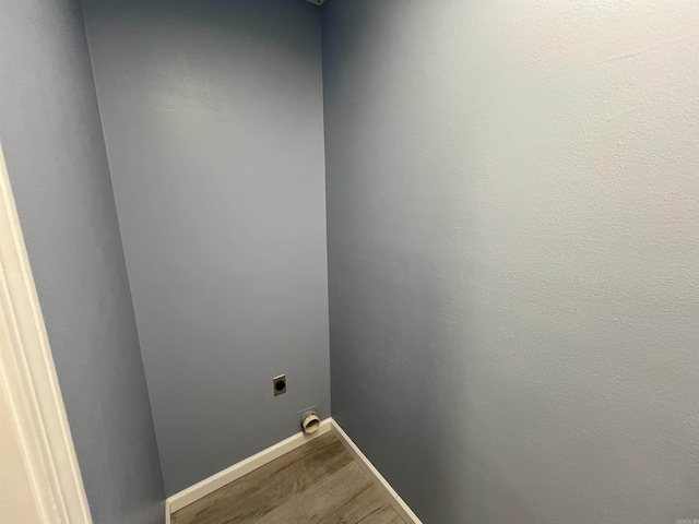 washroom with hardwood / wood-style flooring and electric dryer hookup