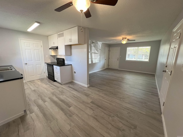 kitchen with ceiling fan, black electric range oven, a textured ceiling, light hardwood / wood-style flooring, and white cabinetry