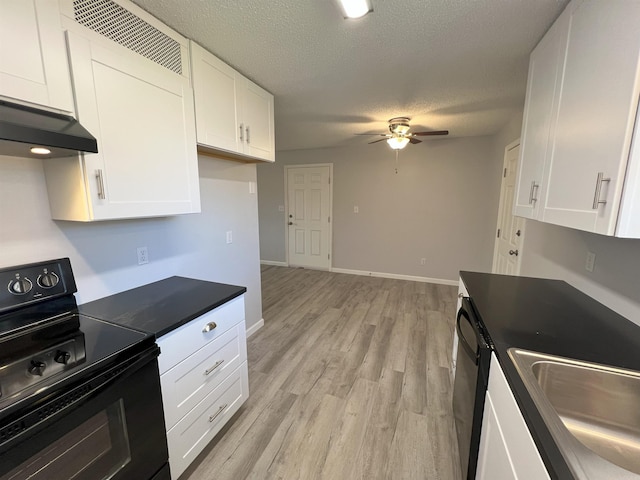 kitchen with light wood-type flooring, ceiling fan, white cabinets, black range with electric cooktop, and a textured ceiling