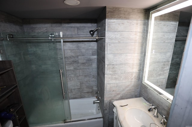 bathroom featuring vanity and bath / shower combo with glass door