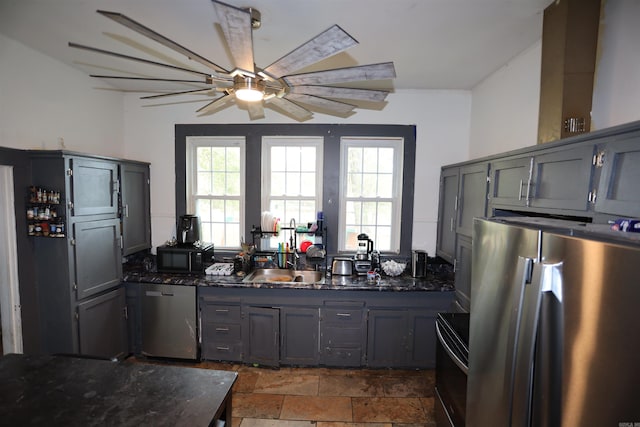 kitchen featuring appliances with stainless steel finishes, gray cabinetry, a healthy amount of sunlight, and ceiling fan