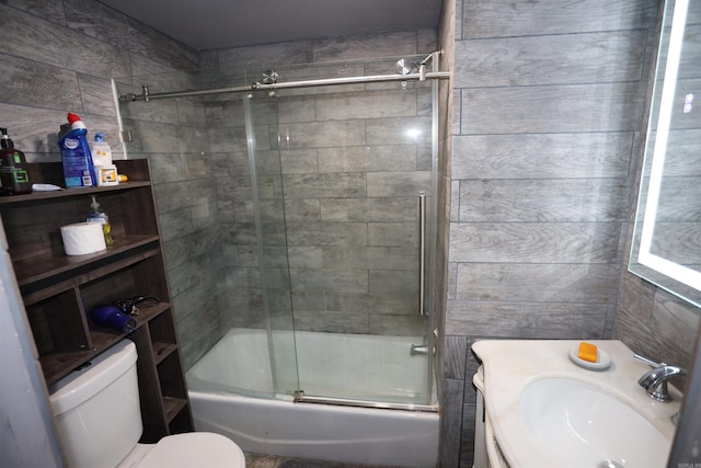 full bathroom with vanity, combined bath / shower with glass door, and toilet