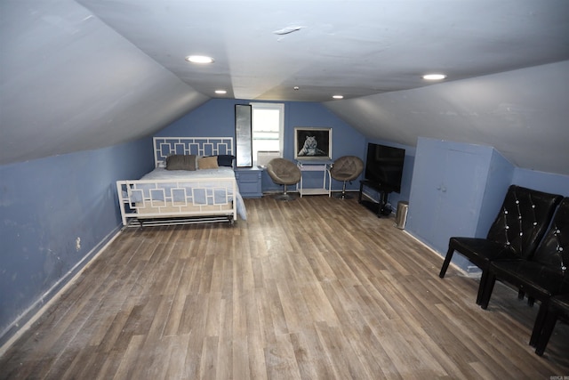 bedroom featuring vaulted ceiling and hardwood / wood-style flooring