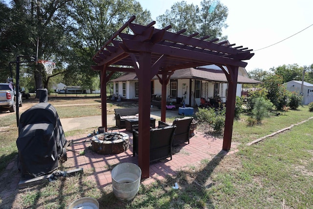 view of patio / terrace with an outdoor fire pit and a pergola