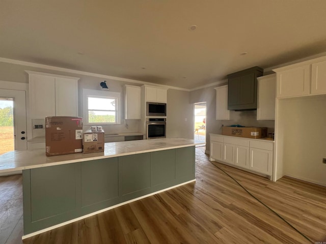 kitchen featuring stainless steel appliances, light countertops, and a spacious island