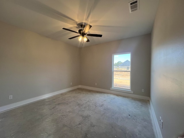 unfurnished room with a ceiling fan, visible vents, concrete floors, and baseboards