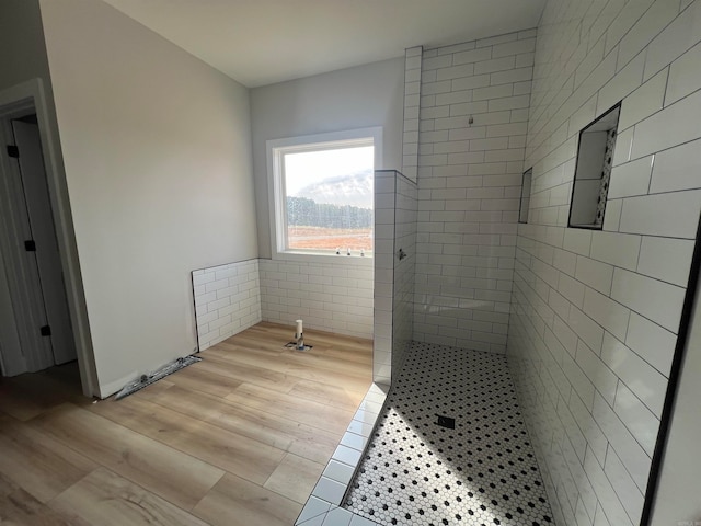 full bath featuring a stall shower and wood finished floors