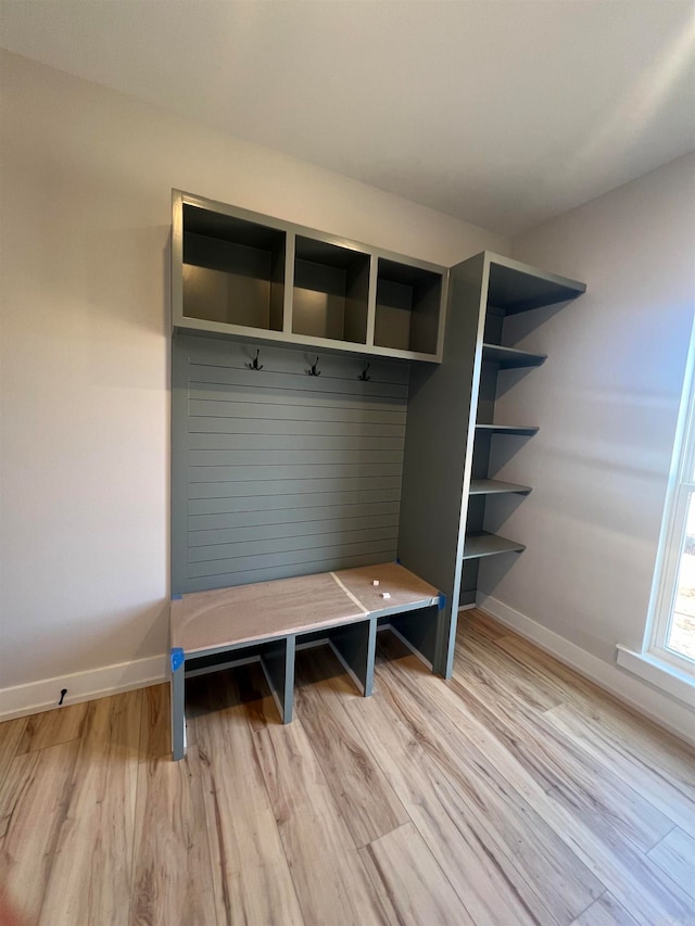 mudroom featuring light wood-type flooring and baseboards