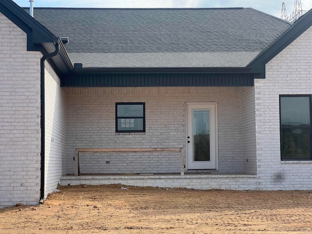 doorway to property with brick siding