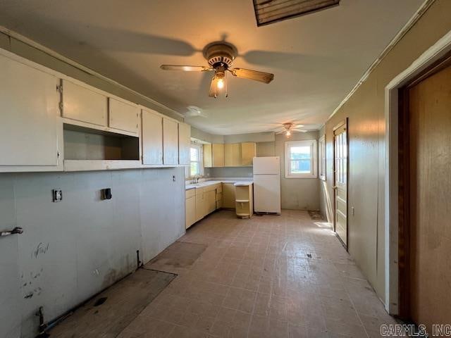 kitchen with ceiling fan, white refrigerator, and sink