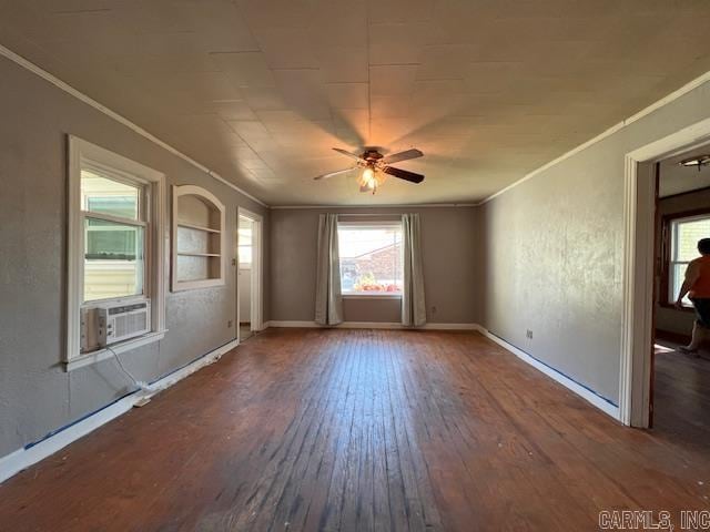 spare room featuring ceiling fan, cooling unit, crown molding, and dark wood-type flooring