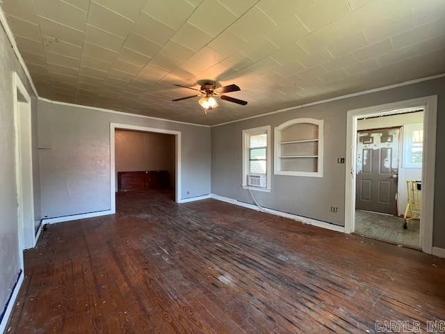 unfurnished room featuring ceiling fan, dark hardwood / wood-style flooring, and built in shelves