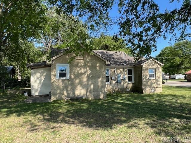 rear view of property with a lawn