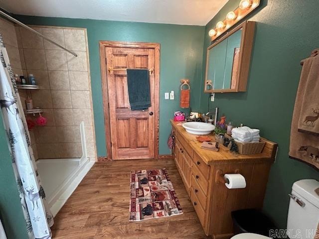 bathroom with vanity, hardwood / wood-style floors, toilet, and a shower with shower curtain