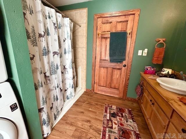 bathroom featuring wood-type flooring, vanity, and a shower with shower curtain