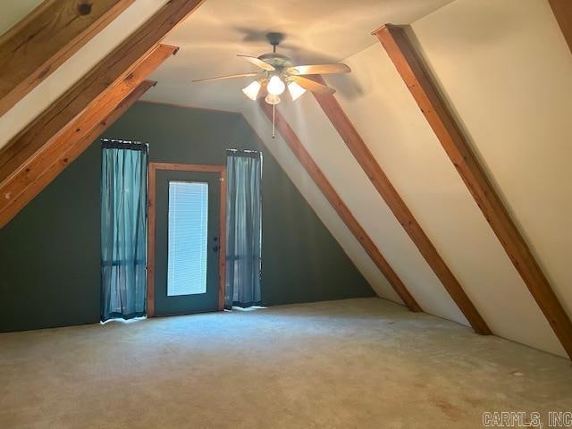 additional living space featuring ceiling fan, vaulted ceiling with beams, and light colored carpet