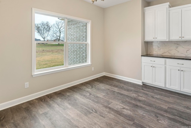 unfurnished dining area featuring dark hardwood / wood-style floors