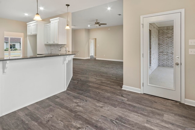 kitchen featuring white cabinetry, sink, ceiling fan, dark wood-type flooring, and decorative light fixtures