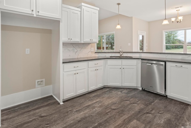 kitchen with dark wood-type flooring, sink, hanging light fixtures, stainless steel dishwasher, and a wealth of natural light