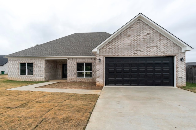 view of front facade with a front yard and a garage