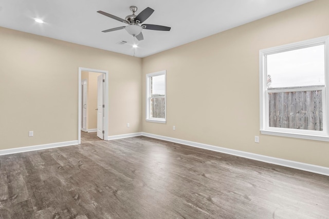 spare room featuring ceiling fan and dark wood-type flooring