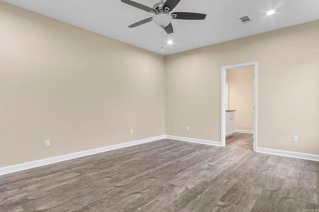 unfurnished room with ceiling fan and wood-type flooring