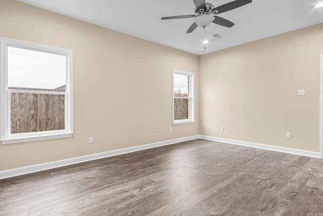 empty room featuring dark hardwood / wood-style flooring and ceiling fan