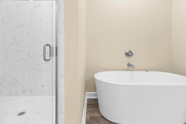 bathroom with hardwood / wood-style floors and separate shower and tub