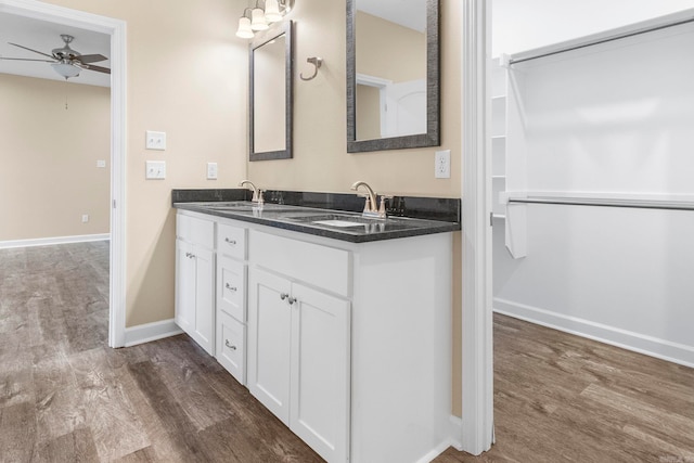 bathroom with wood-type flooring, vanity, and ceiling fan