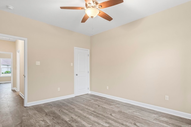 empty room featuring ceiling fan and light hardwood / wood-style floors