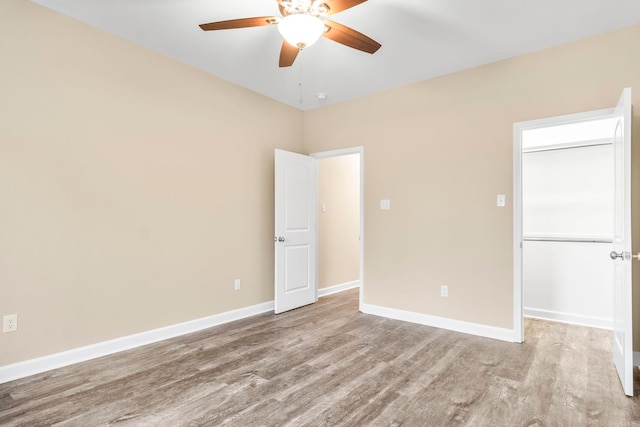 unfurnished room with ceiling fan and light wood-type flooring