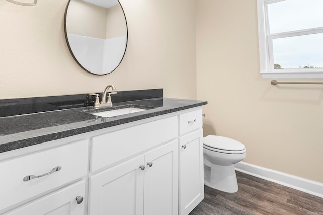 bathroom featuring vanity, hardwood / wood-style flooring, and toilet