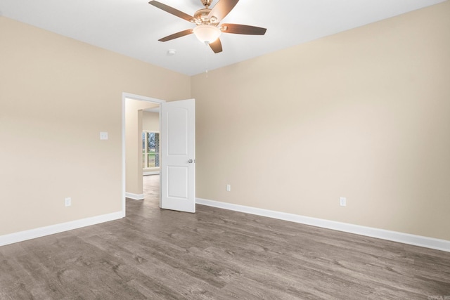 unfurnished room with ceiling fan and wood-type flooring