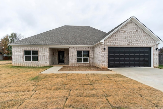 view of front of property with a garage and a front yard