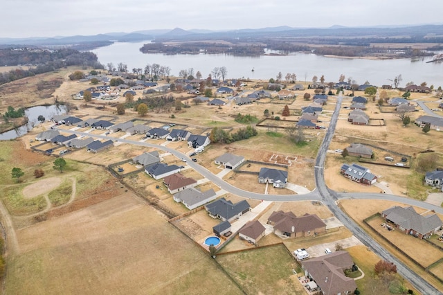 drone / aerial view with a water and mountain view