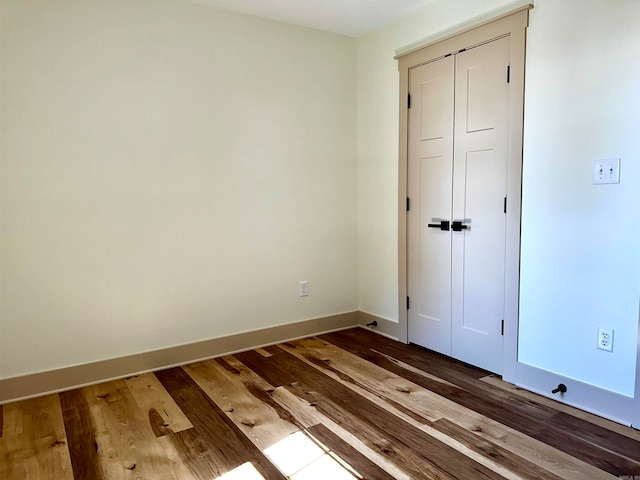 unfurnished bedroom featuring hardwood / wood-style flooring