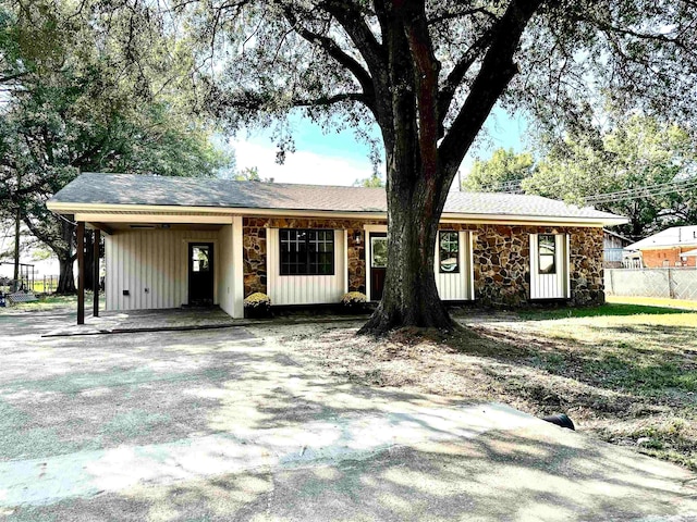 ranch-style house featuring a carport