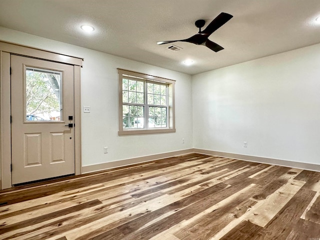 foyer entrance featuring ceiling fan, a textured ceiling, and hardwood / wood-style floors