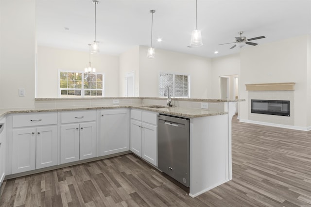 kitchen featuring stainless steel dishwasher, dark hardwood / wood-style floors, white cabinetry, and sink