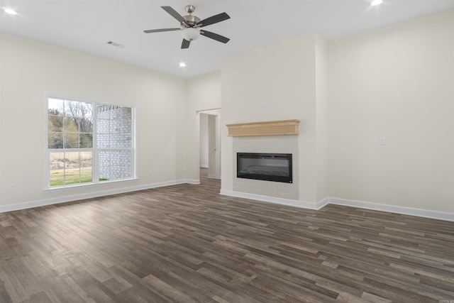 unfurnished living room featuring dark hardwood / wood-style floors and ceiling fan