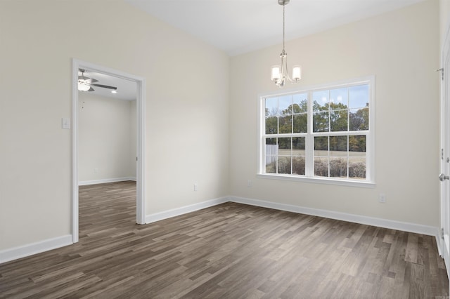 unfurnished dining area with dark hardwood / wood-style floors and ceiling fan with notable chandelier