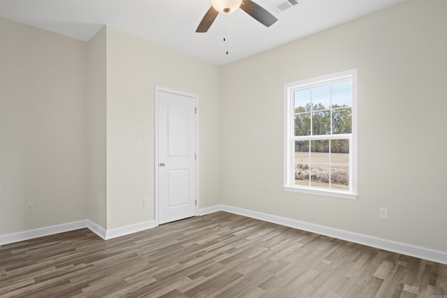 empty room featuring hardwood / wood-style flooring and ceiling fan