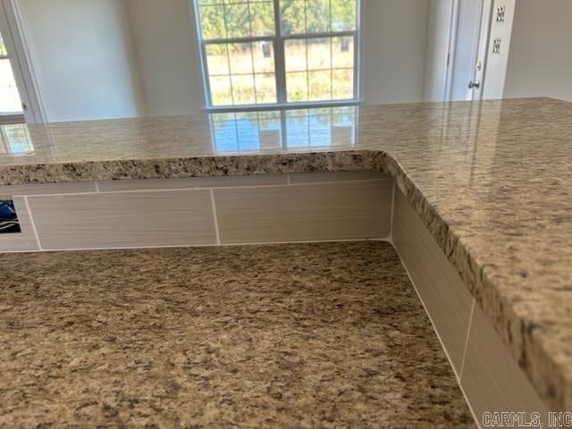 kitchen featuring light stone countertops