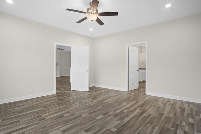 unfurnished bedroom featuring dark hardwood / wood-style floors, ensuite bath, and ceiling fan