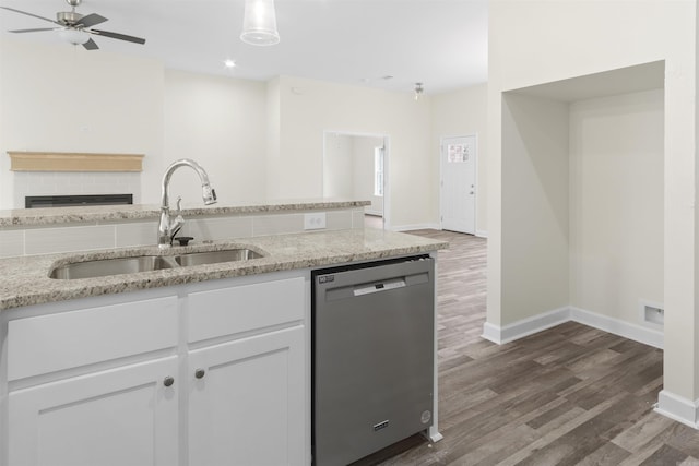 kitchen featuring sink, stainless steel dishwasher, dark hardwood / wood-style flooring, light stone counters, and white cabinetry