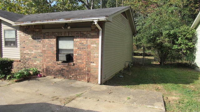 view of property exterior featuring a yard, a patio area, and cooling unit