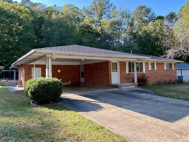 single story home with a front yard and a carport