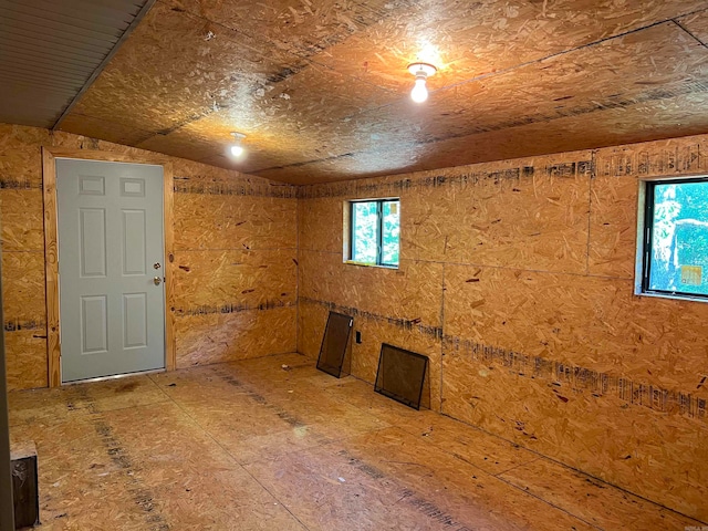 unfurnished room featuring vaulted ceiling